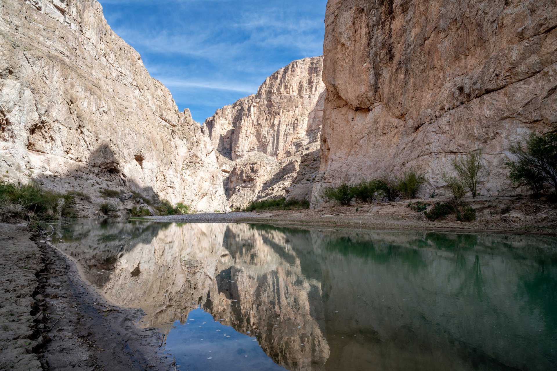 Oasis water between golden desert mountains in Sinai